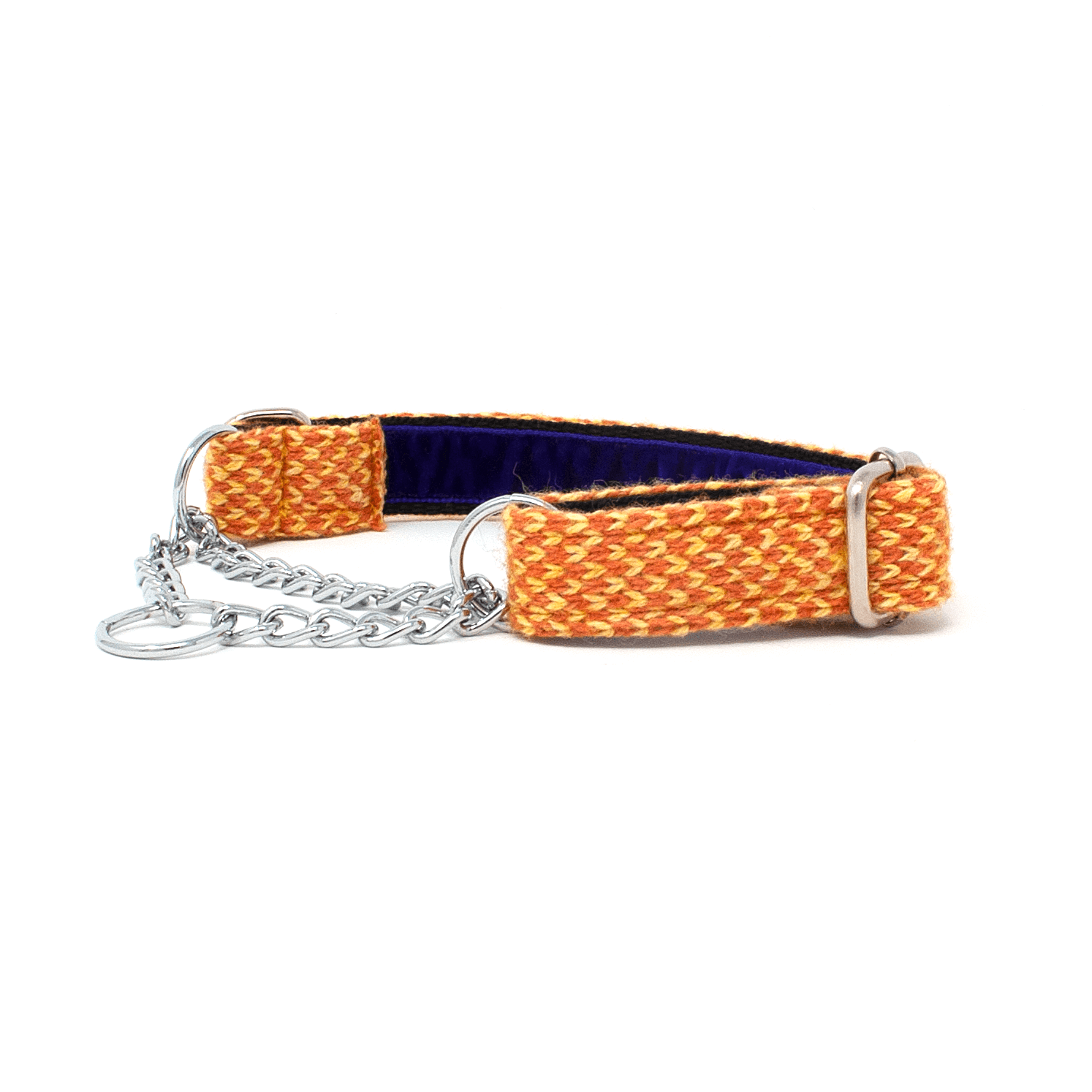 Golden Retriever puppy laying on the sand looking to the right of the shot. the puppy is wearing a pink dog collar and has a pink rope leash attached.